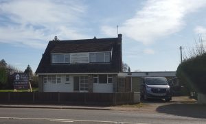 View of a dormer bungalow on the main road in Little Budworth
