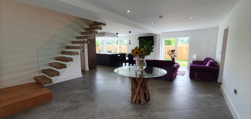 Interior of Little Budworth house showing cantilevered timber stair treads and glass balustrade